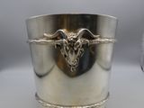 a silver cup with a goat head on it