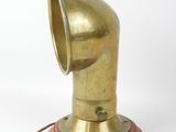 a brass lamp with a wooden base on a white background