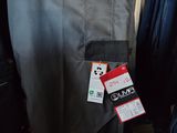 several pairs of jeans hanging on a rack in a clothing store