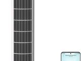 a white tower fan sitting next to a phone on top of a table