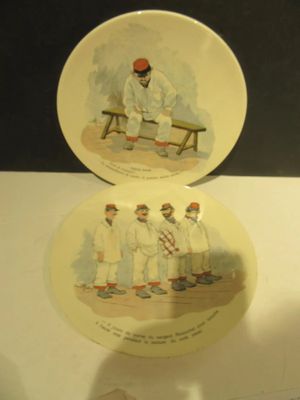 two plates with a picture of a man sitting on a bench