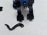 the lego robot is sitting on the table next to the toy
