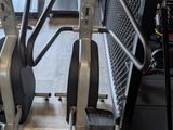a row of stationary exercise bikes in a gym