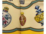 a close up of a scarf with vases and vases on it