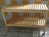 a wooden shelf with a shelf underneath it on a tiled floor