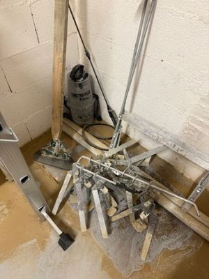 a pile of tools sitting on the floor next to a wall