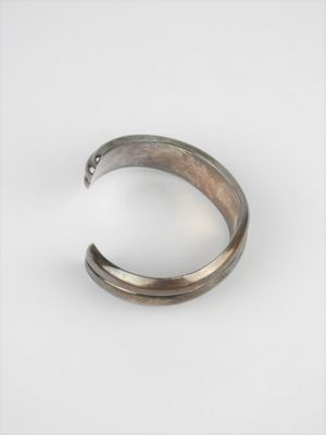 a close up of a metal ring on a white surface
