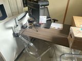 un bureau avec un ordinateur et une chaise dans la chambre
