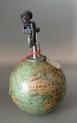 a green globe with a red string around it