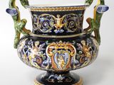 a large vase with a dragon handle on it