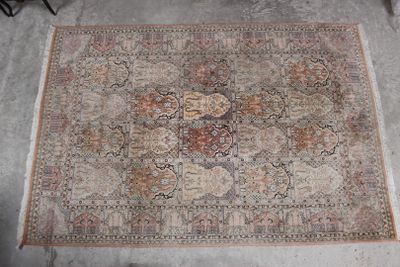 a rug on the floor with a chair in the background