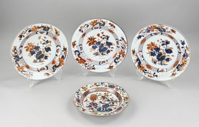 three plates and a bowl with floral designs on them on a table