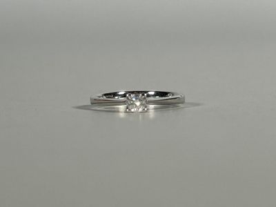 a close up of a diamond ring on a table
