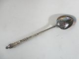 a spoon that is sitting on a white table