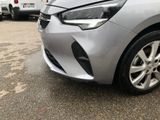 a silver car parked in a parking lot with other cars in the background