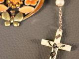 a cross and a rosary on a table