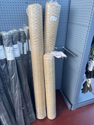 many rolls of fabric on the shelf in the store