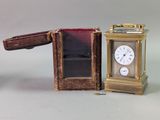 a small clock sitting next to a small box
