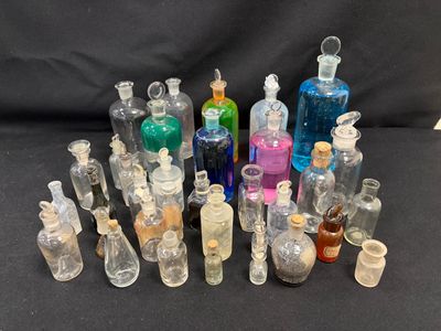 a lot of bottles with different colored liquids in them