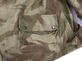 the jacket is camouflaged and has a metal buckle on the front