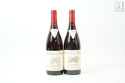 two bottles of red wine sitting next to each other on a white surface