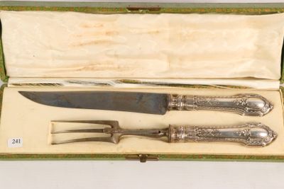 two knives and a fork in a green box