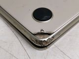 a close up of a cell phone with a hole in the back
