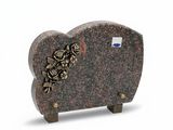a stone sculpture of a sheep with flowers on it