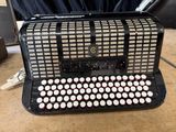 a black and white accordion sitting on a table