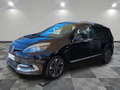 the black car is parked on a checkered floor in the garage