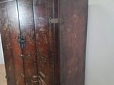 a wooden cabinet that has been painted red and brown