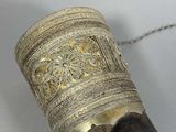 a close up of a large horn with a chain around it