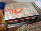 a stack of boxes and a pair of scissors on top of a bed