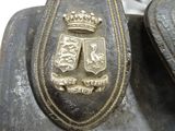 a close up of a metal object with a crown on it