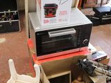 a microwave sitting on top of a cart in the middle of a living room