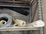 a pile of construction materials on a shelf in a room