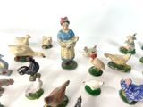 many figurines of people and animals on the table