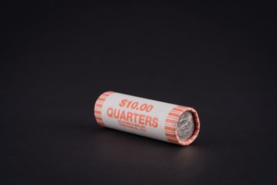 a close up of a roll of cigarettes on a black surface