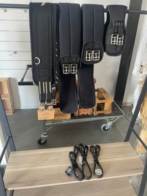 a rack with several pairs of boots and a pair of shoes on it