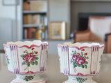 two vases sitting on a table in a living room