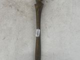 a wooden stick with a bird on it laying on the snow