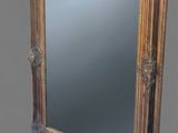 an image of a gold framed mirror on a grey background