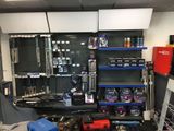 a picture of a garage with tools and tools on the shelves