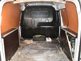 the interior of a van with the door open and the floor covered in dirt