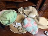 many hats that are sitting on a table