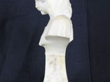 a white marble bust of a woman with a hood on her head