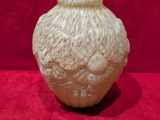 a vase that is sitting on a red surface
