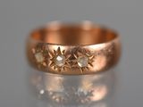 a close up of a gold ring with a star design on it