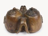 an image of a bronze figurine of two birds on a branch