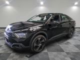 a black suv parked in a room with a checkered floor